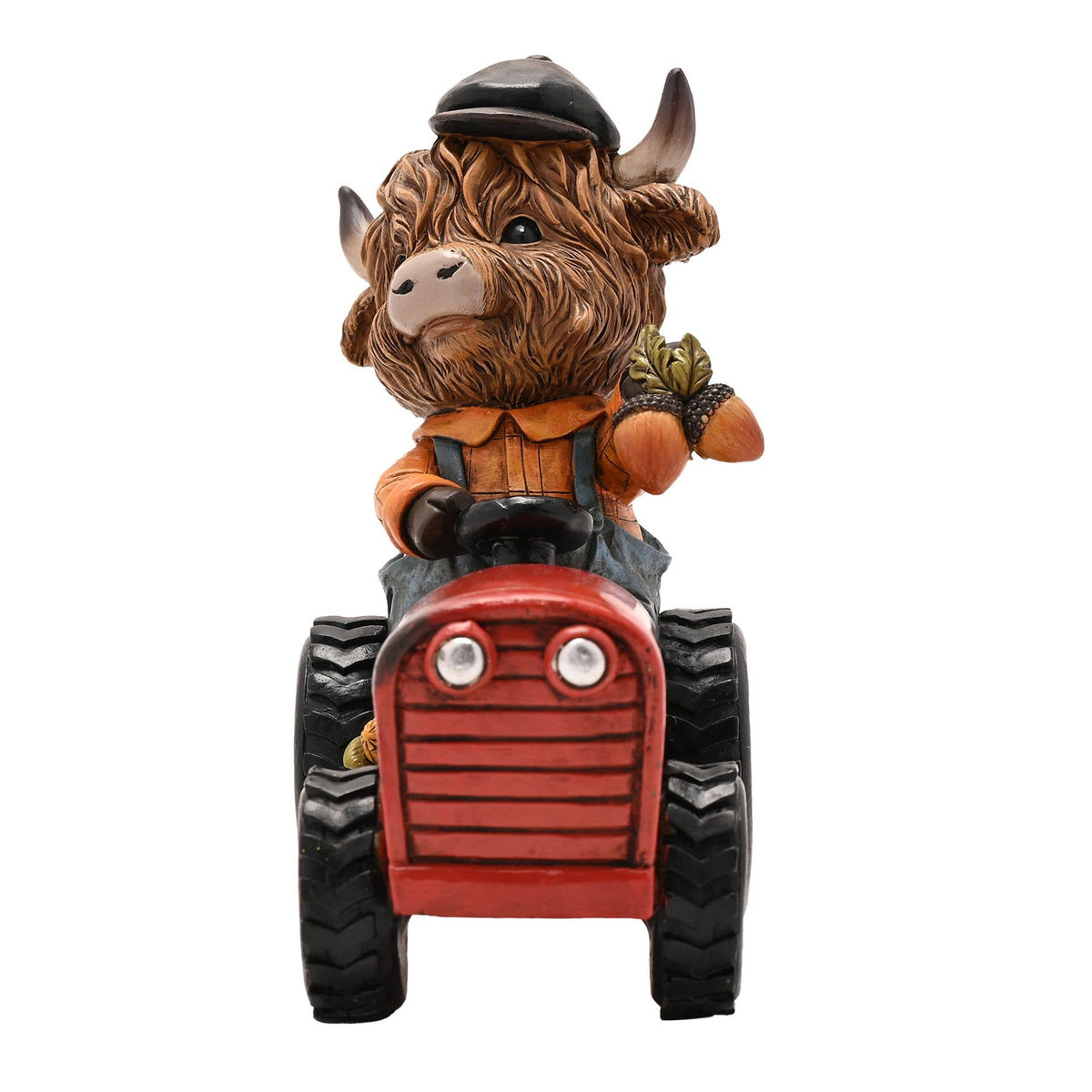 Vache Highland de Country Living sur un tracteur