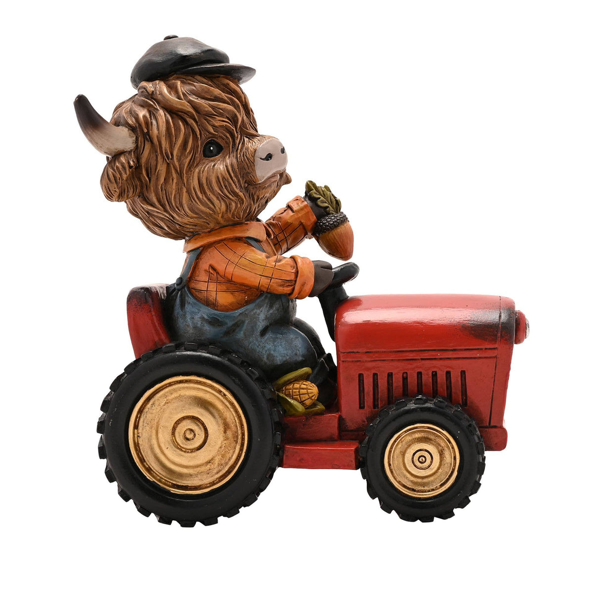 Vache Highland de Country Living sur un tracteur